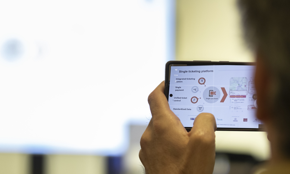 Image of a delegate taking a picture of a presentation