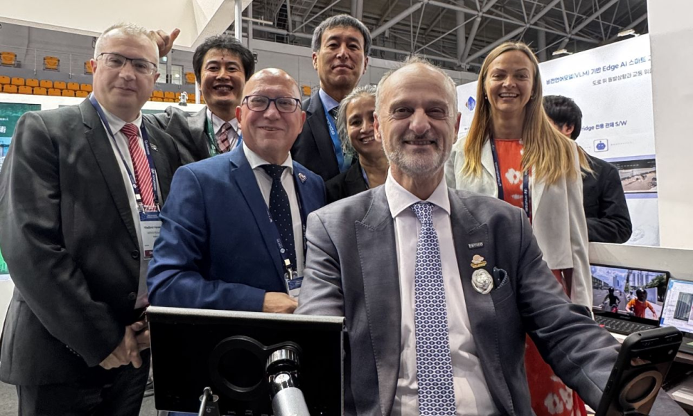 Photograph of members of the ERTICO team, including Dr. Angelos Amditis, trying a simulator at the Gangneung 2026 ITS World Congress 